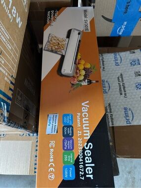 Vacuum Sealer Machine in Orange and Black Packaging